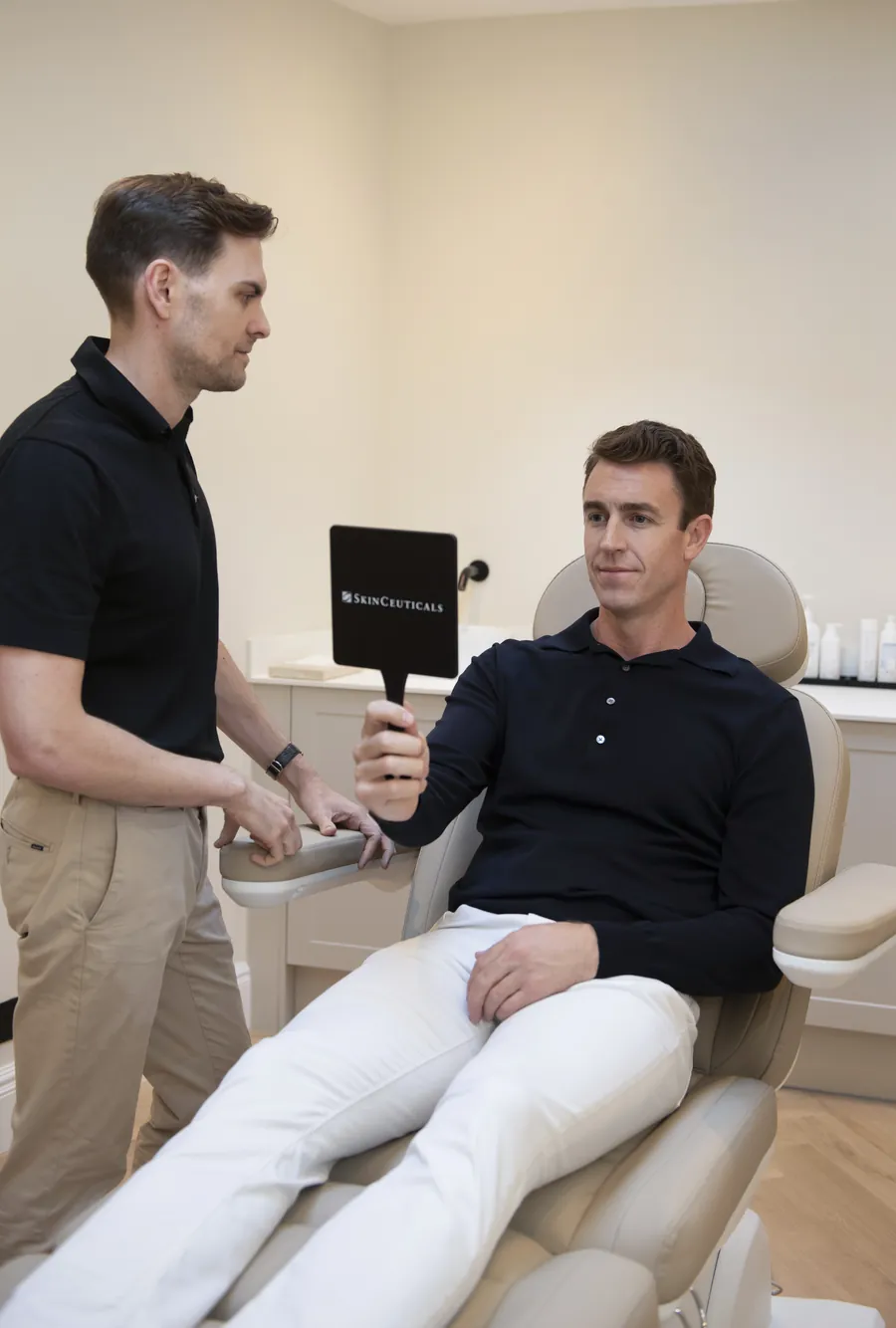 A patient reviewing their skin with a clinician at The Heath Clinic